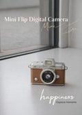 Vintage style brown mini flip digital camera held in hand