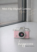 Vintage style pink mini flip digital camera held in hand