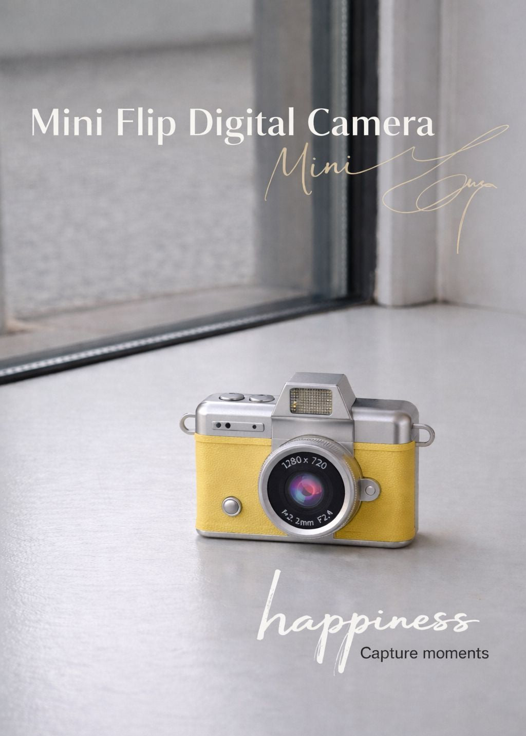 Vintage style yellow mini flip digital camera held in hand