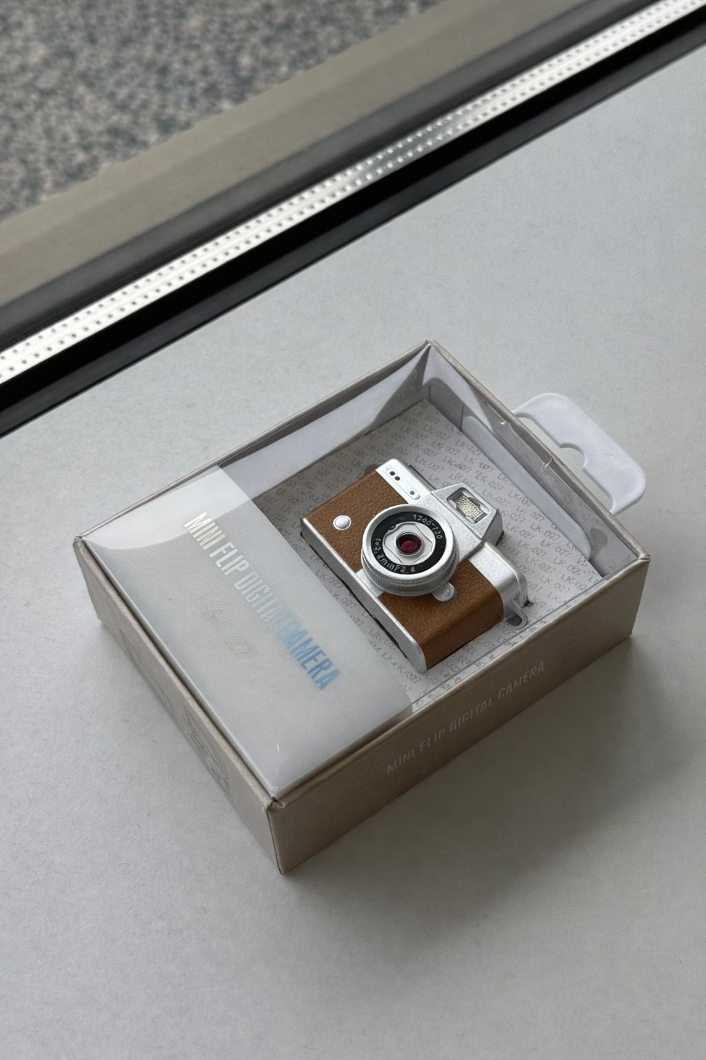 Brown mini digital camera in gift box packaging