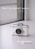 Vintage style white mini flip digital camera held in hand