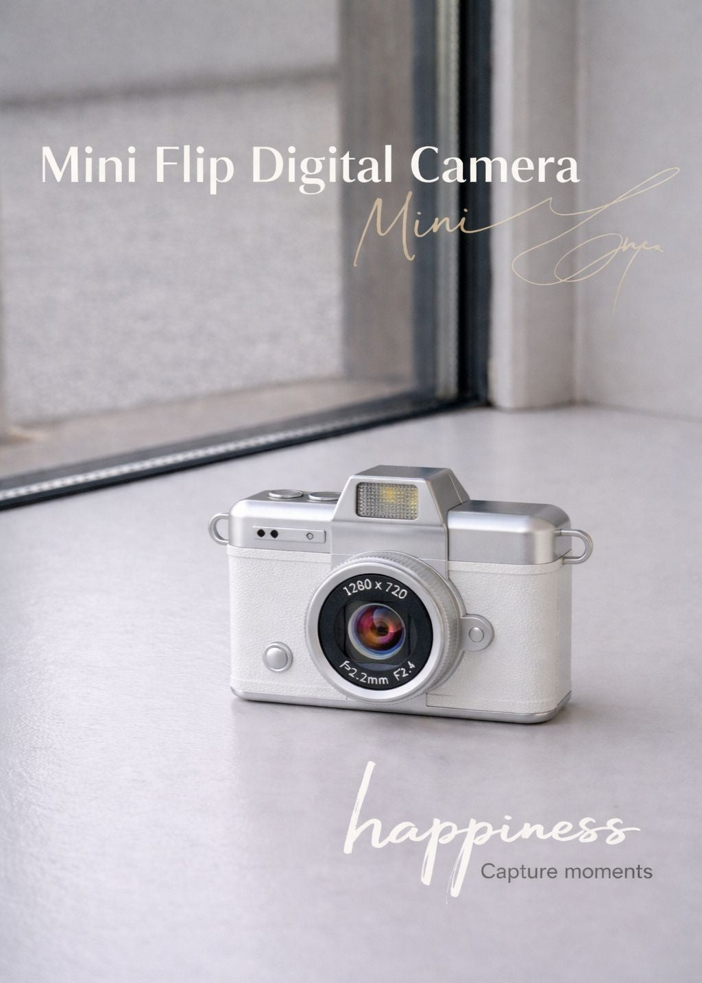 Vintage style white mini flip digital camera held in hand